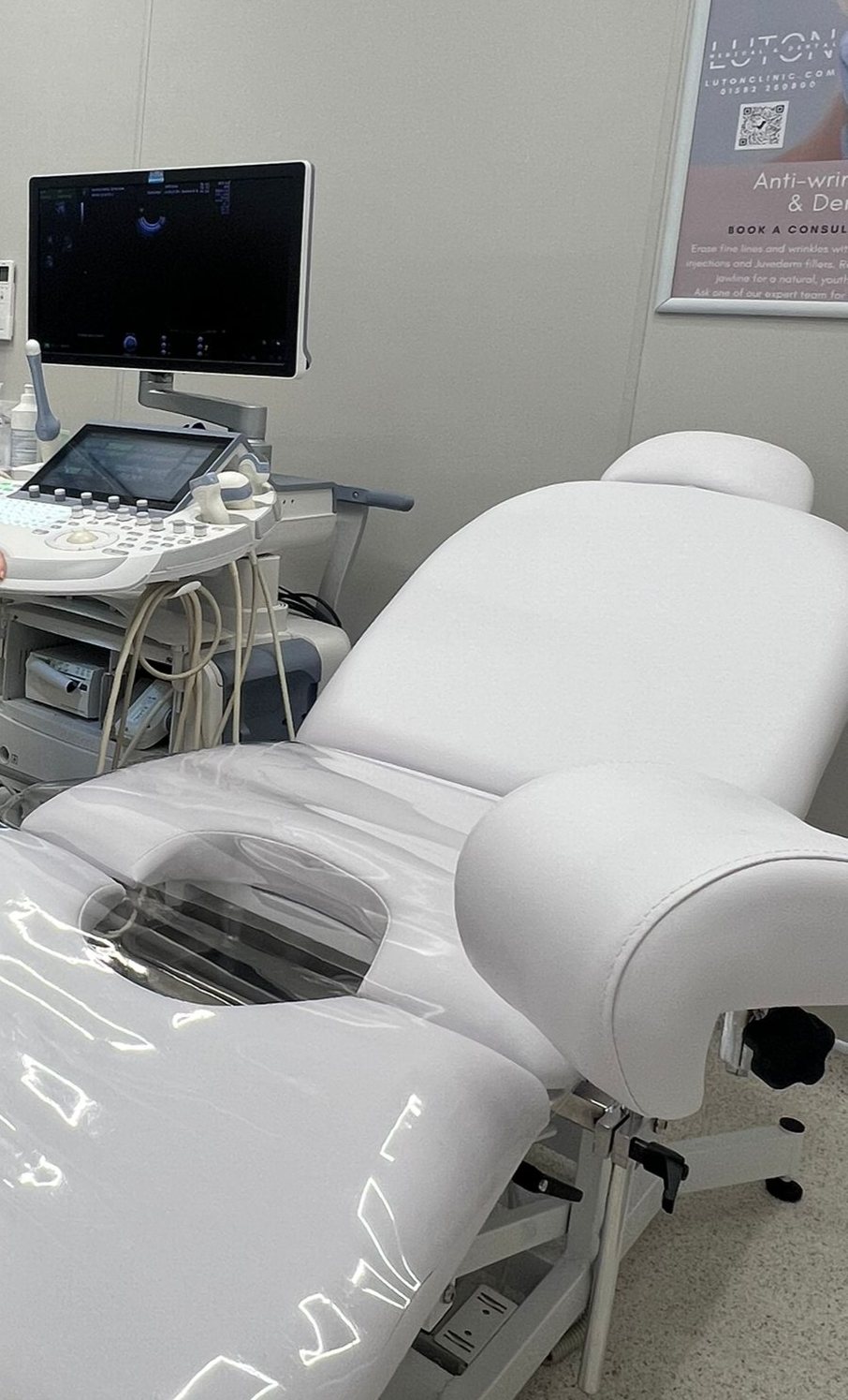 The ultrasound room at Luton Medical & Dental Clinic, a white couch beside the scanner